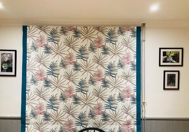 Picture of roman blind that is down that has borders both sides to emphasise one of the colours in the main fabric