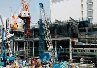 Heavy machinery and cranes working on a large scale site development and infrastructure project