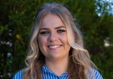 a white woman smiling in a striped shirt outdoor portrait photography