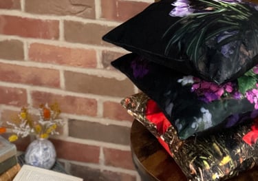 stack of handmade velvet cushions with vibrant floral photographic prints