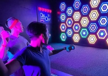 a man and woman playing a game of laser light up
