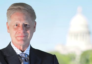 Arkansas Wrongful Death Lawyer Gene Ludwig poses in front of State Capital Building