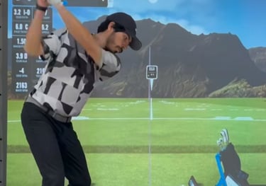 a man playing golf on a golf simulator