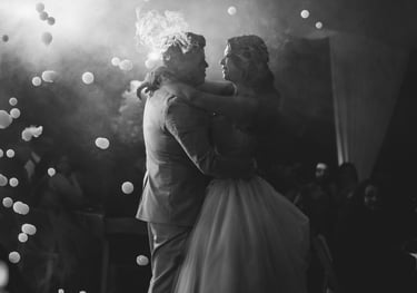 a bride and groom share a kiss at their wedding reception