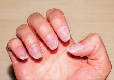 a person's hand holding a piece of nail polish