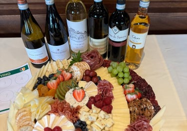 charcuterie on a clothed table with bottles of wine for a consumer tasting