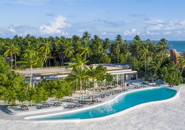 a large pool with a swimming pool and a view of the ocean, St Regis Maldives