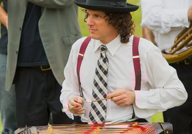 David Ansel playing tsimbl during a Mazel Tov Kocktail Hour show