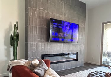 Mounted TV above custom tile fireplace in modern North Peoria living room.