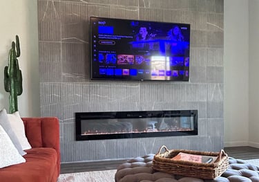 Close-up of mounted TV on tiled fireplace wall with hidden wiring.