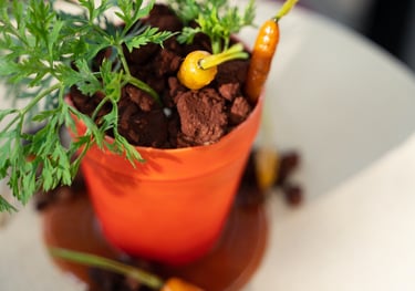 a dessert of a potted carrot cake plant that looks real by Paola Marocchi
