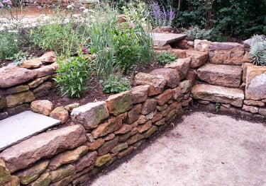 Natrural landscaping using local stone with a colourful natural planting scheme