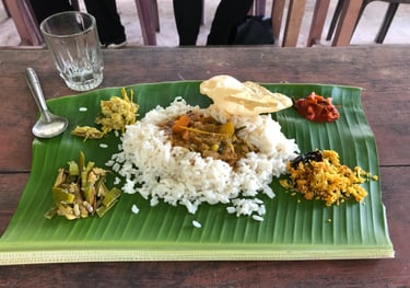 keralan food served on a banana leaf, in Kochi, Kerala, India