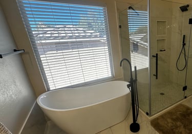 a remodeled bathroom with a stand alone tub and a walk in shower