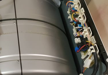 Opened dryer top revealing visible control board for repair.
