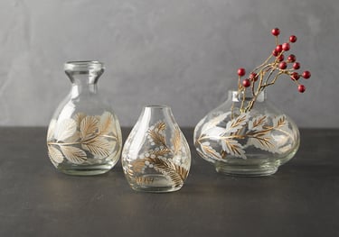 three vases with pine cones etching and gold hand paintedand berries in them