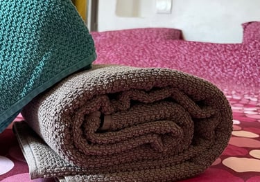 Serviettes de bains pliées sur un lit