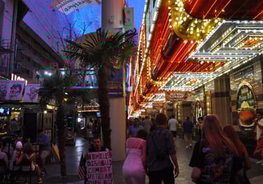 a group of people walking down Fremont street in las vegas