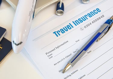 a pen on travel insurance paper