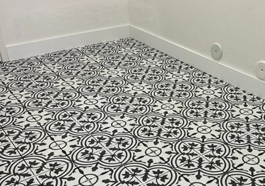 Installed tile flooring with new baseboards in laundry room