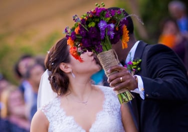 Bride and Groom kissing. Bouquet covering faces. Countryside Wedding The Comus Inn in Dickerson, MD
