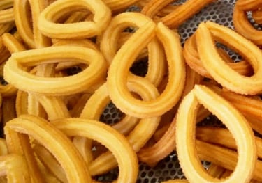 a bunch of churrons that are sitting on a metal mesh basket