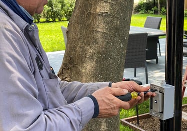 landscape lighting technician installing a dimmer switch