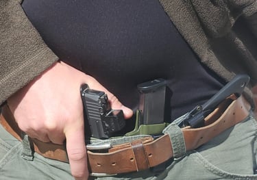 Man grips defensive firearm from concealment.