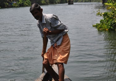 guide punting boat in Kochi, Kerala, India