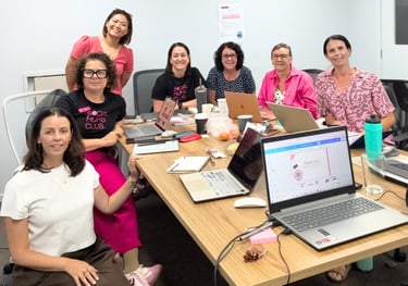Group of small business owners participating in a beginner-friendly digital workshop with laptops an