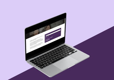 a laptop computer screen showing a website page on a purple background