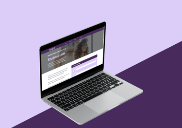 a laptop computer screen showing a website page on a purple background
