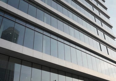 A modern office building exterior in Yemen with glass panels and a clean, sophisticated design. The architecture is professional and represents a stable and growing business presence in the Middle East.