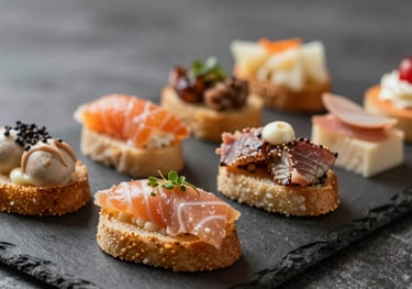 A beautifully arranged selection of gourmet finger foods and appetizers on a dark slate tray, highlighting bespoke culinary excellence.