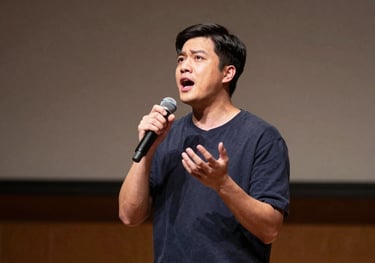 An action shot of an actor performing a dramatic monologue on a North American / US university stage, highlighting intensity and lighting.