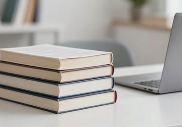 A bright, clean image of a student's desk with a stack of textbooks and a laptop. The focus is on the textures of the paper and the modern feel of the workspace.