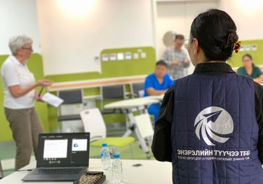 Professional educational seminar with a presenter leading a workshop for healthcare staff.