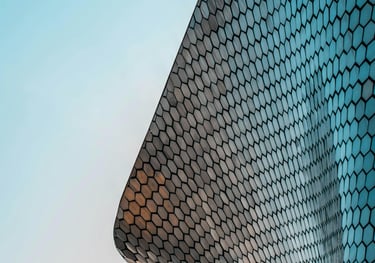 Low-angle view of the modern Soumaya Museum architecture with its reflective silver hexagonal tiles.