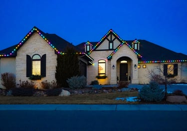 Luxury home featuring colorful LED Christmas roof lights and festive holiday outdoor lighting.