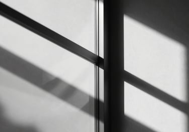 Abstract photography of light passing through optical glass, creating clean lines and geometric shadows, minimalist black and white style.