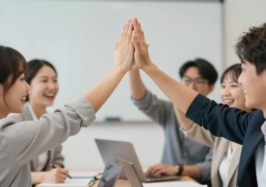 Team members high-fiving during a workshop, captured in a candid and energetic shot, focusing on emotion and connection.