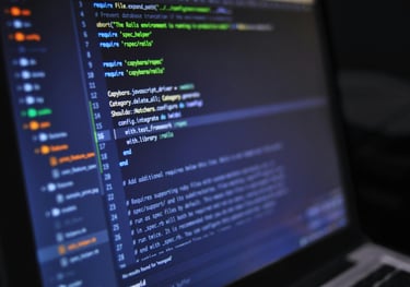 Lifestyle image of laptop computer screen with green, yellow and blue text on it.