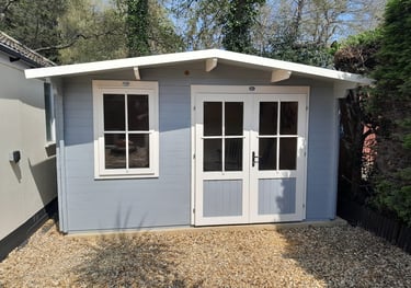 a garden cabin in Poole painted grey and white