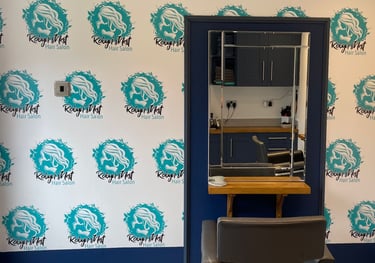 a chair with a mirror and a mirror in the background