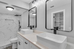 a bathroom with a large mirror and a sink