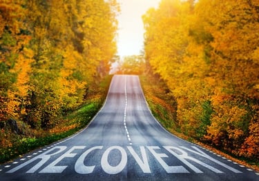 a road with a road sign that says recovery