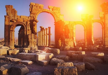 a large arch in a desert landscape with a bright sun shining through the arches