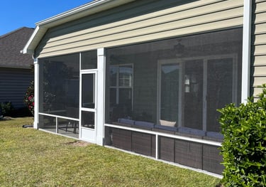 Comfortable screen porch seating with outdoor furniture and throw pillows