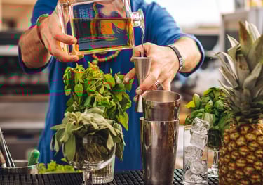 a man is making a tequila cocktail with a bottle of uno tequila añejo - premium tequila añejo