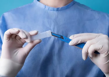 a person in a blue shirt and gloves holding a piece of paper